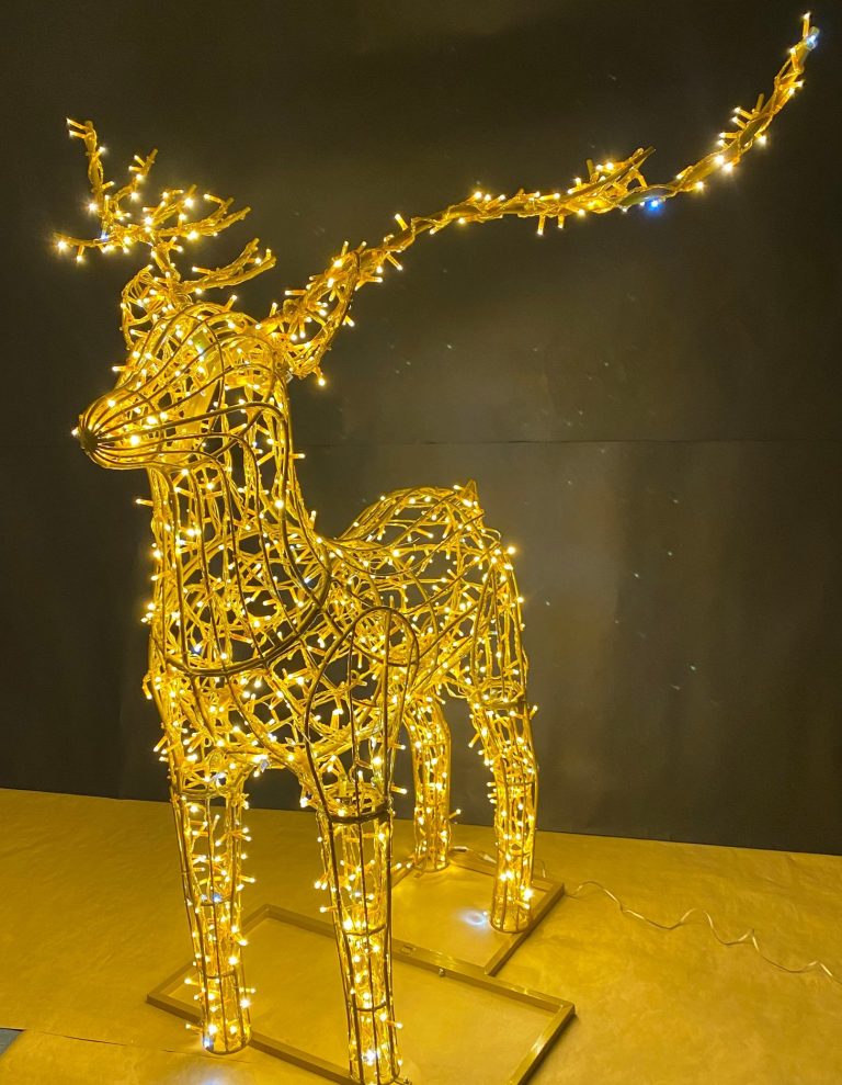 Goldene Rentier-Silhouette mit LED-Lichtern vor dunklem Hintergrund.